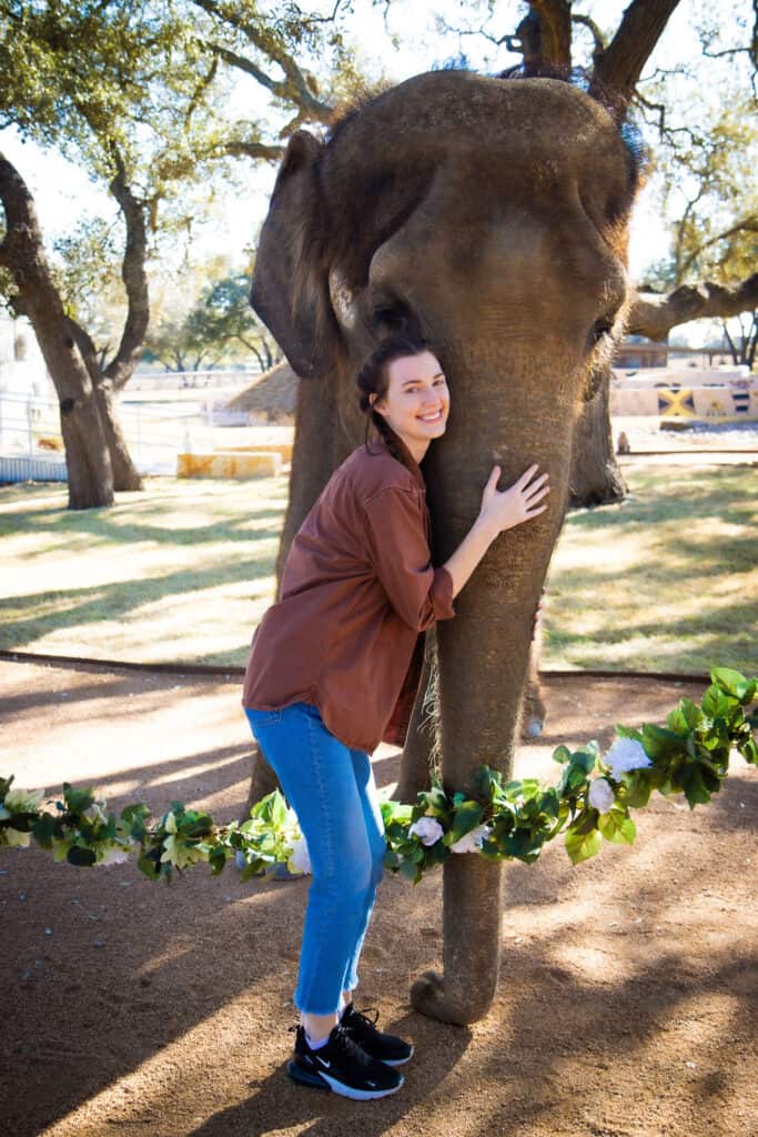 jenni hold elephant trunk during photo