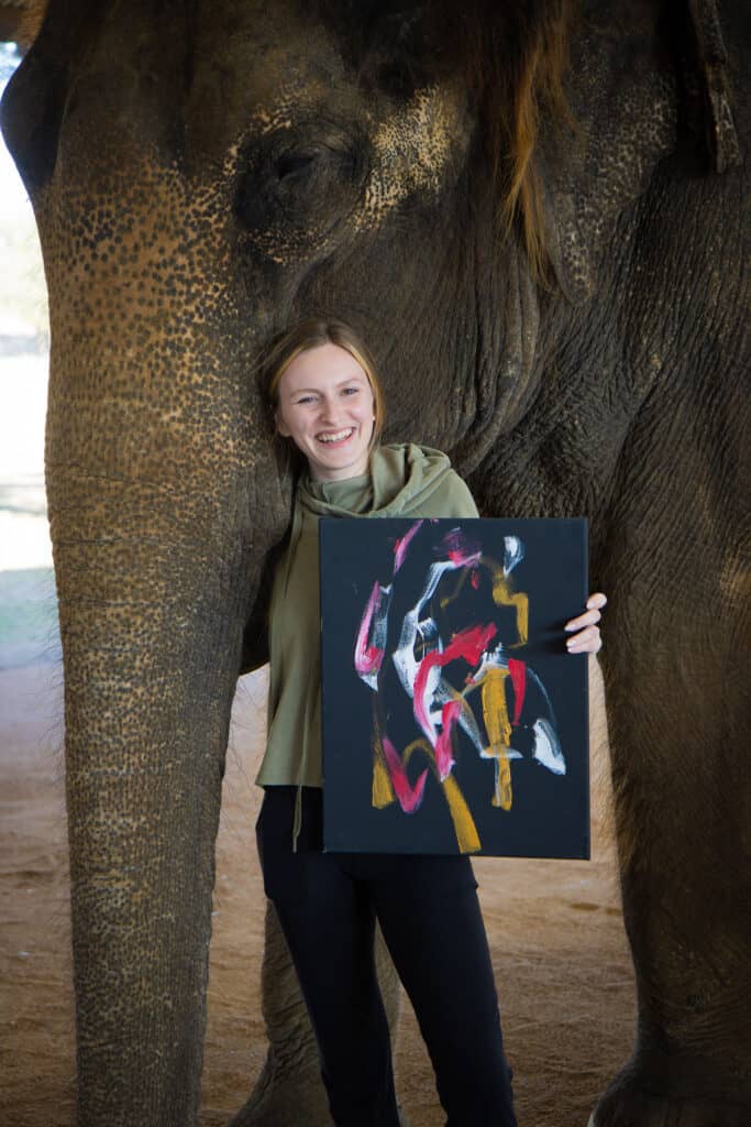emily hold painting with elephant